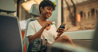 Woman holding a card and a phone
